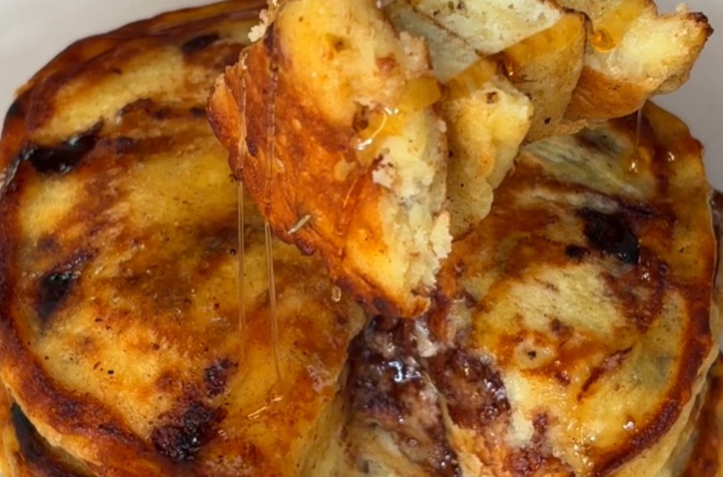 Banana Bread Chocolate Chip Pancakes stacked with maple syrup